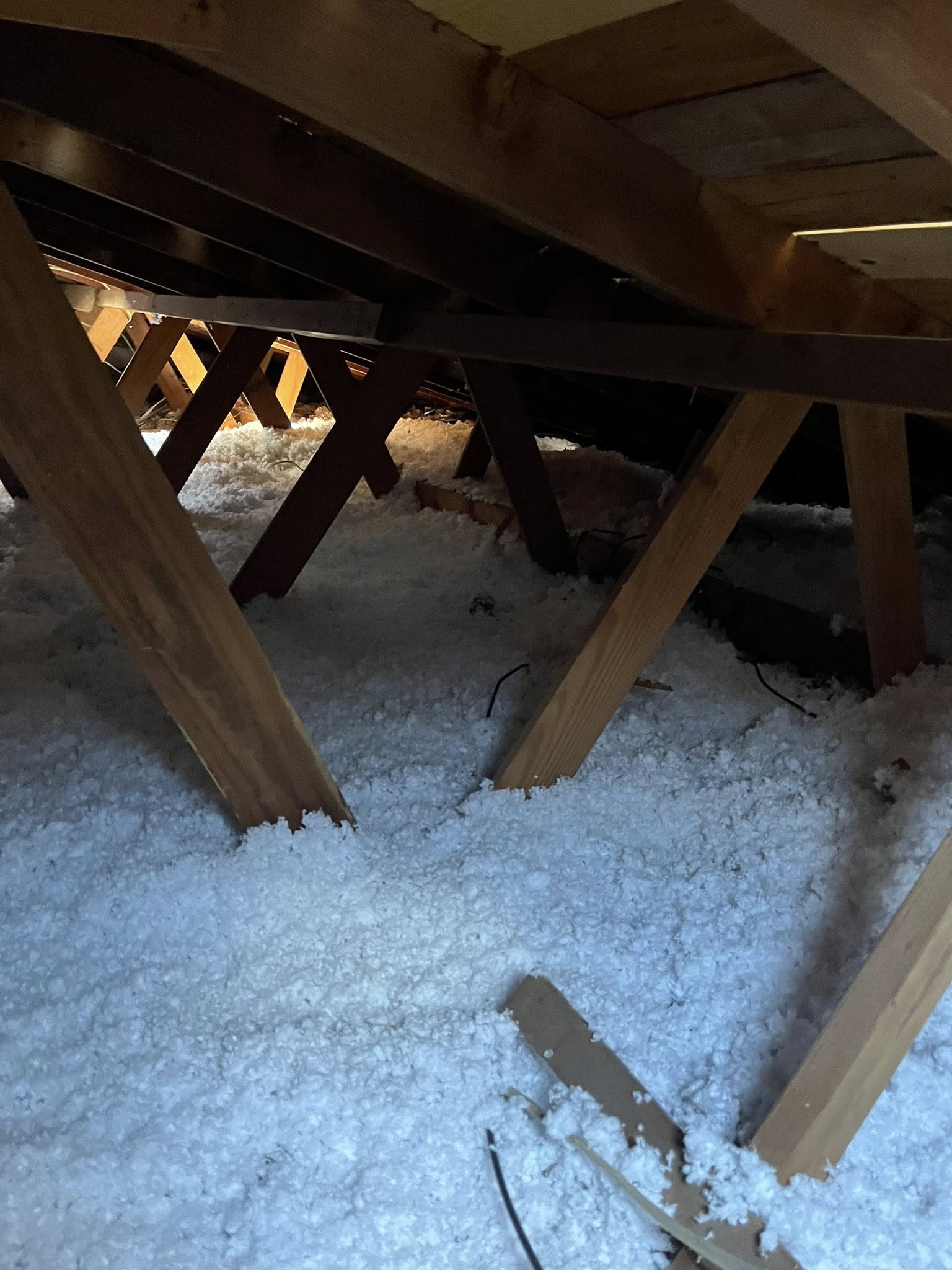 Blown-in fiberglass insulation on the floor of a North Texas attic